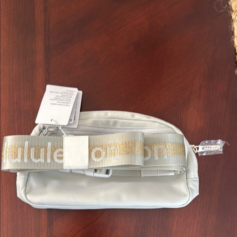 Lululemon Athletica Crossbody Bag in Light Gray and Gold